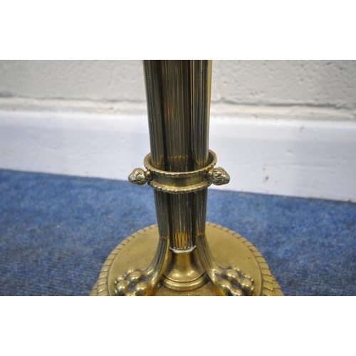 267 - A 20TH CENTURY BRASS STANDARD LAMP, with a foliate pillar, triple rams head, three scrolled supports... 