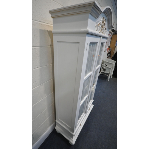 272 - A WHITE PAINTED CABINET, with double glazed doors, thats enclosing shelves, over two drawers, raise... 