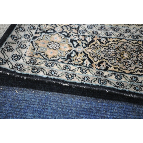 278 - A RECTANGULAR WOOLEN RUG, with various colours, geometric patterns, surrounded by a multi-strap bord... 