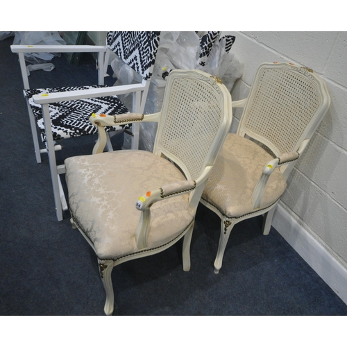 284 - A PAIR OF CREAM PAINTED ARMCHAIRS, with cane backrests, and foliate upholstery, along with a set of ... 