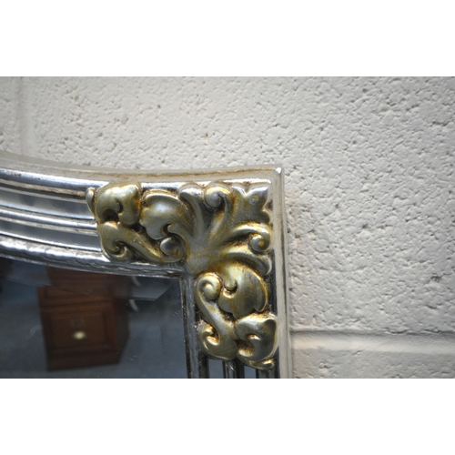 290 - A SILVER AND GOLD PAINTED ARCHED OVERMANTEL BEVELLED EDGE WALL MIRROR, 217cm x 90cm, condition repor... 