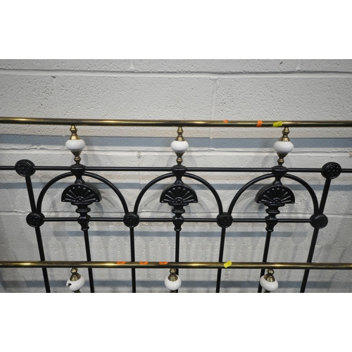 292 - A BLACK TUBULAR METAL 4FT6 BEDSTEAD, with side rails, slats, and bolts, condition report: one cerami... 