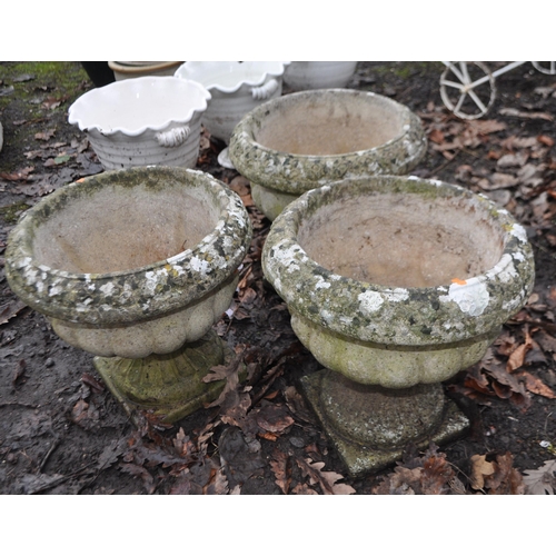 10 - A SET OF THREE WEATHERED COMPOSITE GARDEN PLANTERS with fluted detail to blustered bowls, Condition ... 