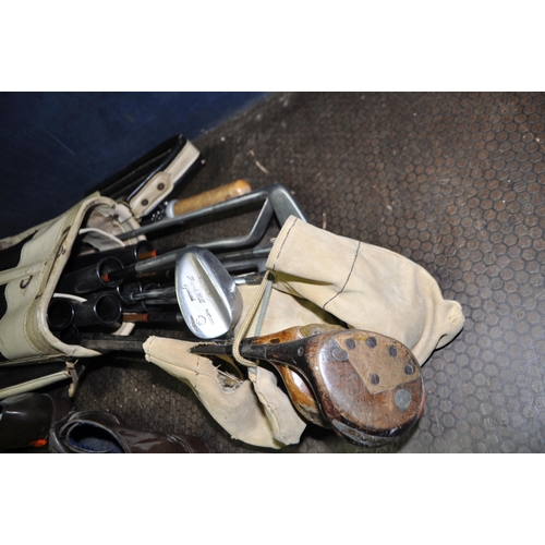 108 - A VINTAGE GOLF BAG CONTAINING CLUBS including a hickory shafted Punch Putter by F. Thomas etc