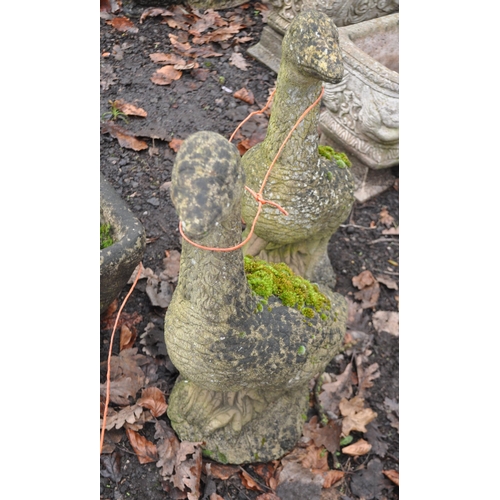 13 - A PAIR OF WEATHERED COMPOSITE GARDEN FIGURES IN THE FORM OF WALKING GEESE, heights 60cm, Condition R... 