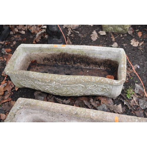 16 - A PAIR OF RECTANGULAR WEATHERED COMPOSITE GARDEN PLANTERS, with mythical creature and human mask det... 