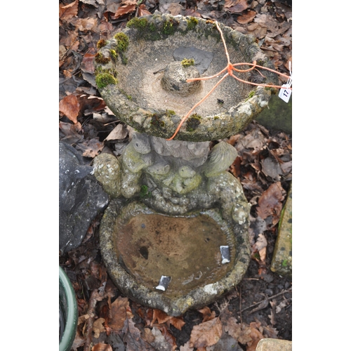 17 - A WEATHERED COMPOSITE BIRD BATH in the form of a tree stump surrounded by squirrels and two bowls, a... 