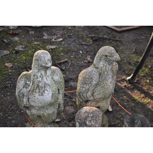 25 - A COLLECTION OF MODERN COMPOSITE GARDEN FIGURES, including a pair of birds of prey, a boot, a cartoo... 