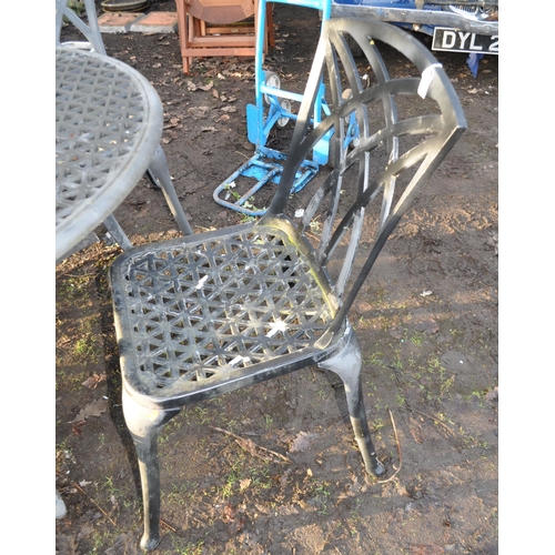 26 - A CAST ALUMINIUM GARDEN TABLE AND FOUR MATCHING CHAIRS, table diameter 120cm, along with a parasol a... 