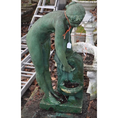 29 - A PAINTED COMPOSITE GARDEN FIGURE ON STAND in the form of a lady washing at a well head, constructed... 