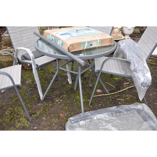 4 - A MODERN GLASS TOPPED METAL GARDEN TABLE, table diameter 90cm, with four matching chairs, loose cush... 