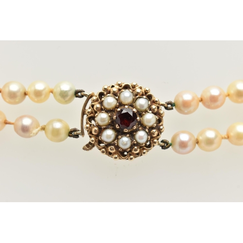 401 - A 9CT GOLD CULTURED PEARL NECKLACE, a double strand necklace of graduated white pearls with cream un... 