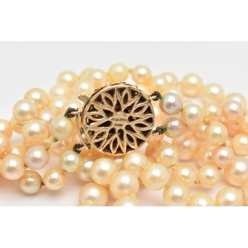 401 - A 9CT GOLD CULTURED PEARL NECKLACE, a double strand necklace of graduated white pearls with cream un... 