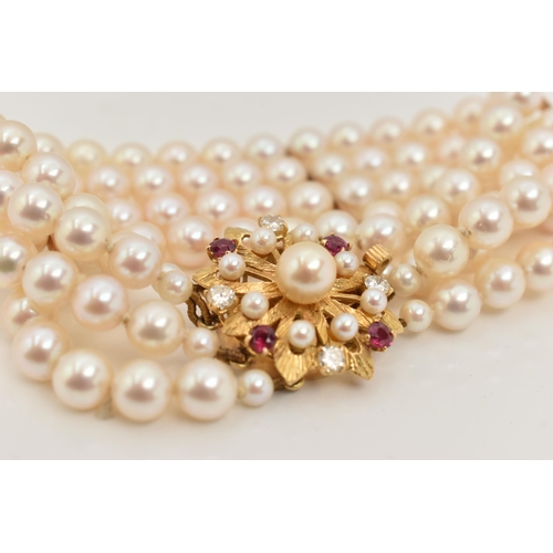 402 - A CULTURED PEARL BRACELET, a four strand bracelet of white cultured pearls with a pink hue, approxim... 