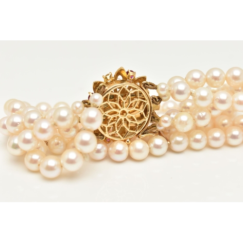 402 - A CULTURED PEARL BRACELET, a four strand bracelet of white cultured pearls with a pink hue, approxim... 