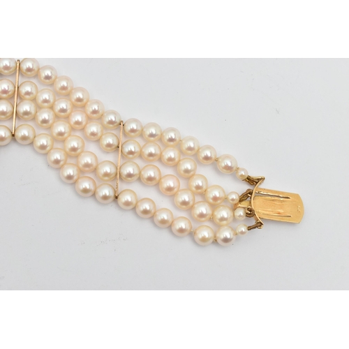 402 - A CULTURED PEARL BRACELET, a four strand bracelet of white cultured pearls with a pink hue, approxim... 