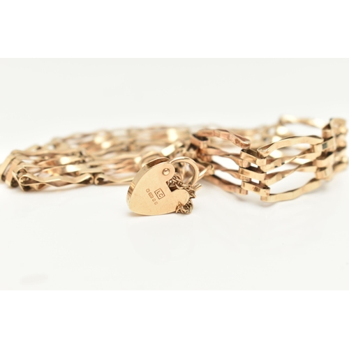 410 - A 9CT GOLD GATE BRACELET, a yellow gold four bar gate bracelet, fitted with a heart padlock clasp, h... 