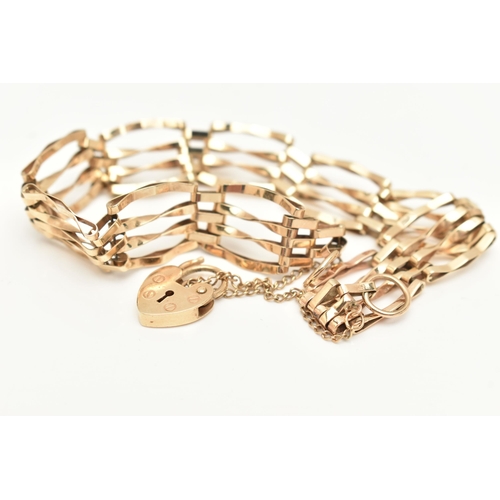 410 - A 9CT GOLD GATE BRACELET, a yellow gold four bar gate bracelet, fitted with a heart padlock clasp, h... 