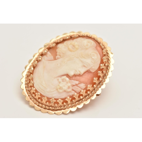 416 - A YELLOW METAL CAMEO BROOCH, carved oval shell depicting a lady in profile, claw set to the scallope... 