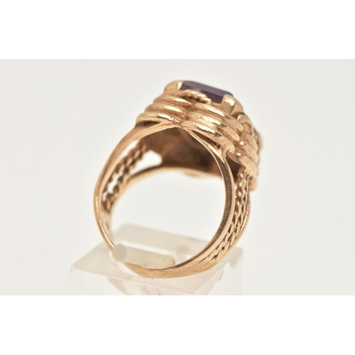 426 - A 9CT GOLD AMETHYST RING, set with a rectangular cut amethyst, four claw set to a stepped scallop su... 