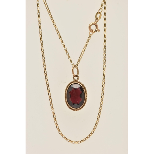 446 - A 9CT GOLD GARNET PENDANT WITH CHAIN, the pendant of an oval form, in a milgrain collet set with a f... 