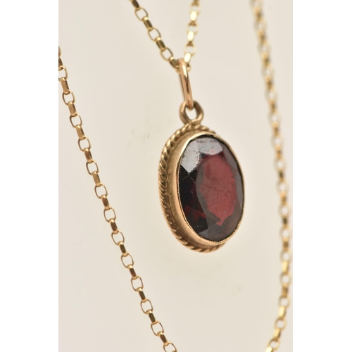 446 - A 9CT GOLD GARNET PENDANT WITH CHAIN, the pendant of an oval form, in a milgrain collet set with a f... 