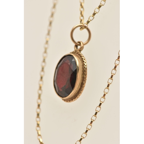 446 - A 9CT GOLD GARNET PENDANT WITH CHAIN, the pendant of an oval form, in a milgrain collet set with a f... 