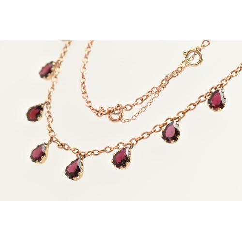 452 - A ROSE METAL GARNET NECKLACE, cable chain fitted with eight pear cut garnet droppers, each in a claw... 