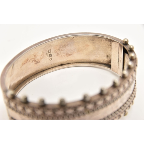 463 - A VICTORIAN SILVER HINGED BANGLE, a wide bangle with beading and etched foliage detail, fitted with ... 