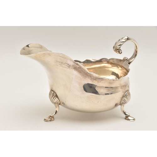 482 - A LATE VICTORIAN SILVER SAUCE BOAT, polished with wavy rim, raised on three hoof feet with shell det... 