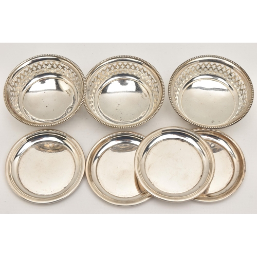 484 - FOUR SILVER COASTERS AND THREE NUT DISHES, four polished circular coasters, each hallmarked 'William... 