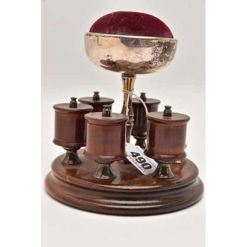 490 - AN EARLY 20TH CENTURY THREAD HOLDER AND PIN CUSHION, a wooden circular base with five thread / spool... 