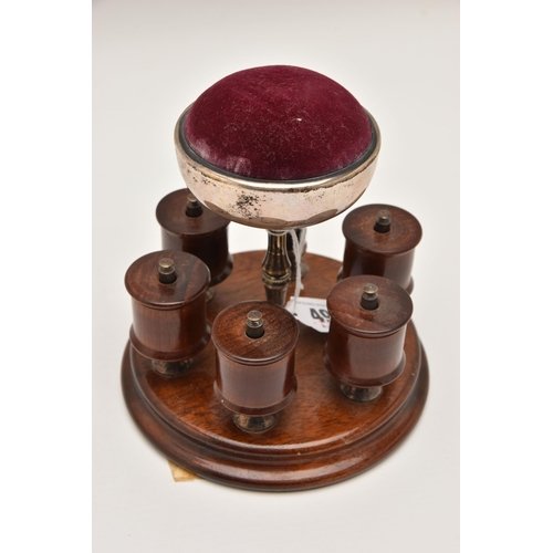 490 - AN EARLY 20TH CENTURY THREAD HOLDER AND PIN CUSHION, a wooden circular base with five thread / spool... 