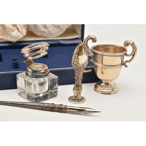 501 - A SILVER WRITING SET AND MINATURE TROPHY, a blue rectangular form case containing a glass inkwell wi... 