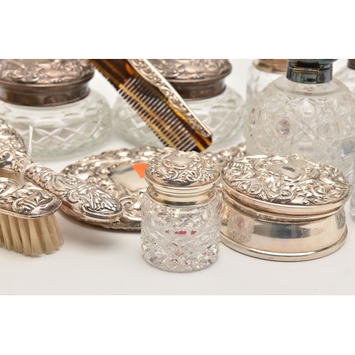 512 - A BOX OF ASSORTED SILVER VANITY ITEMS, to include six glass jars with silver lids, a glass bottle wi... 