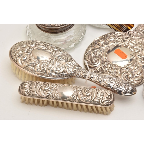 512 - A BOX OF ASSORTED SILVER VANITY ITEMS, to include six glass jars with silver lids, a glass bottle wi... 