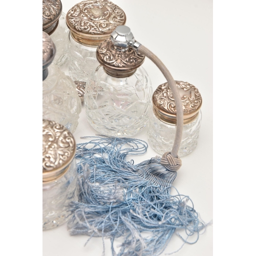 512 - A BOX OF ASSORTED SILVER VANITY ITEMS, to include six glass jars with silver lids, a glass bottle wi... 