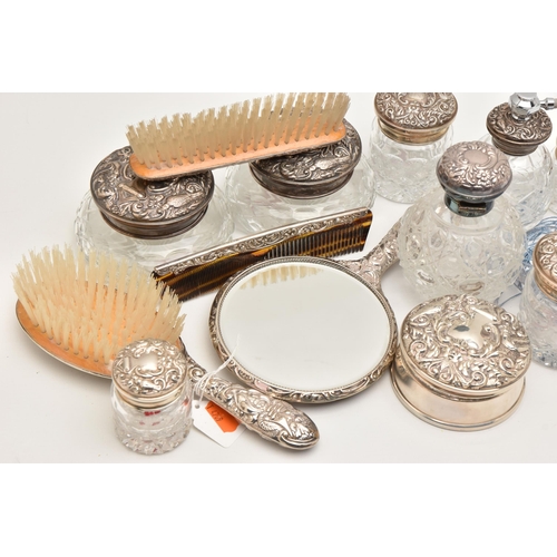 512 - A BOX OF ASSORTED SILVER VANITY ITEMS, to include six glass jars with silver lids, a glass bottle wi... 