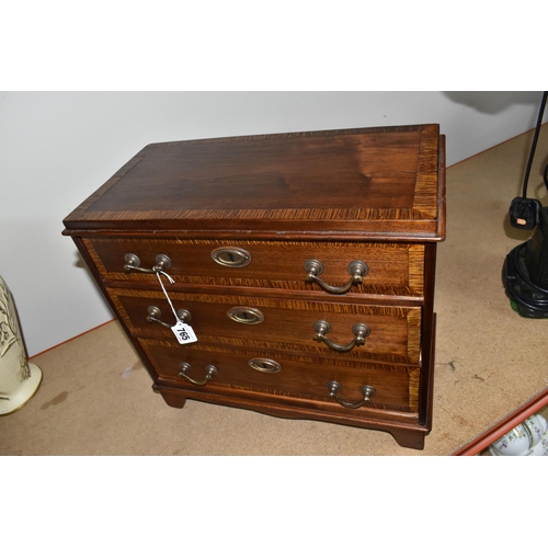 765 - A SAMPLE/APPRENTICE CHEST OF DRAWERS with three drawers decorated with a lighter wood band, each wit... 