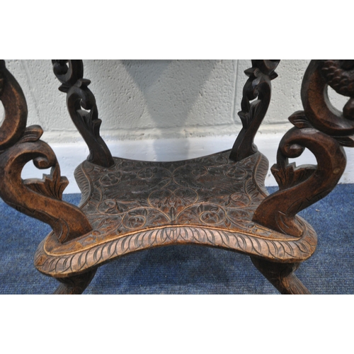 160 - A 20TH CENTURY INDIAN OAK SEWING TABLE, with intricate carved details, the top depicting two birds a... 