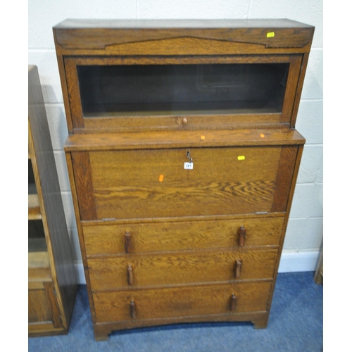 161 - A 20TH CENTURY OAK CABINET, with a detachable glass hide and fall door, atop a base with a fall fron... 