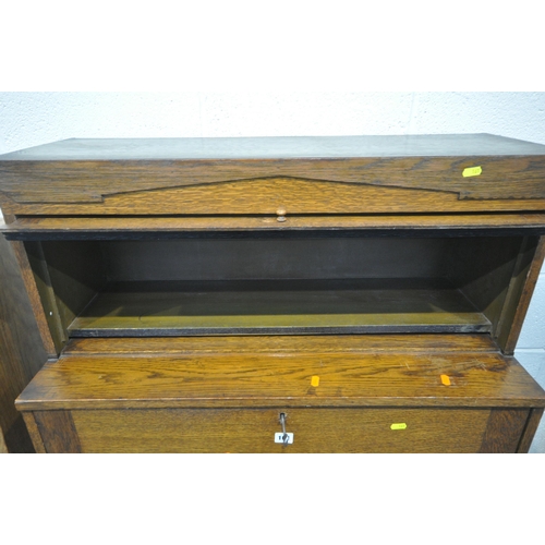 161 - A 20TH CENTURY OAK CABINET, with a detachable glass hide and fall door, atop a base with a fall fron... 