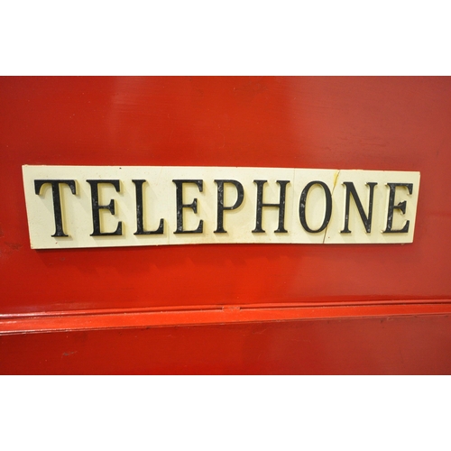 170 - A SCRATCH BUILT RED PAINTED METAL TELEPHONE BOX, the domed top with a clock to the front, the single... 