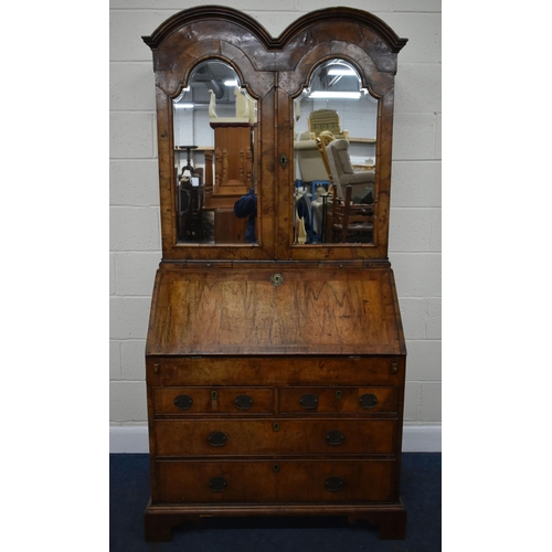 184 - A QUEEN ANNE (CIRCA 1710) FIGURED WALNUT DOUBLE DOME TOP BUREAU BOOKCASE, the double bevelled edge m... 