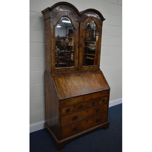 184 - A QUEEN ANNE (CIRCA 1710) FIGURED WALNUT DOUBLE DOME TOP BUREAU BOOKCASE, the double bevelled edge m... 