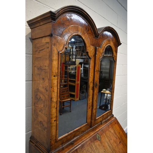 184 - A QUEEN ANNE (CIRCA 1710) FIGURED WALNUT DOUBLE DOME TOP BUREAU BOOKCASE, the double bevelled edge m... 