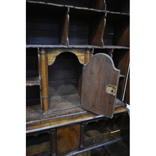 184 - A QUEEN ANNE (CIRCA 1710) FIGURED WALNUT DOUBLE DOME TOP BUREAU BOOKCASE, the double bevelled edge m... 