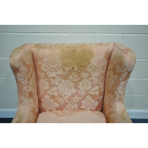 185 - A LARGE GEORGIAN WING BACK ARMCHAIR, with pink floral upholstery, raised on a fruitwood frame, width... 