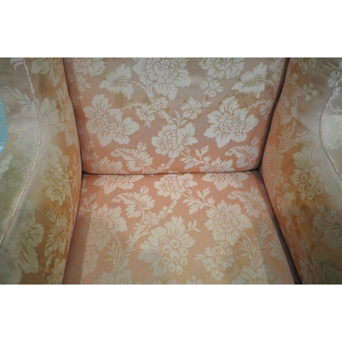 185 - A LARGE GEORGIAN WING BACK ARMCHAIR, with pink floral upholstery, raised on a fruitwood frame, width... 