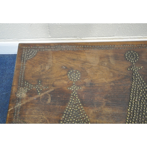 188 - A BRASS-STUDDED HARDWOOD ZANZIBAR CHEST, with twin brass handles, the hinged lid enclosing a candle ... 